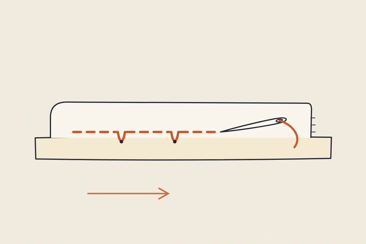 Diagram: the slip stitch catching a folded hem — the needle takes a single thread of the cloth, then travels hidden inside the fold, so almost no stitch shows on the surface.
