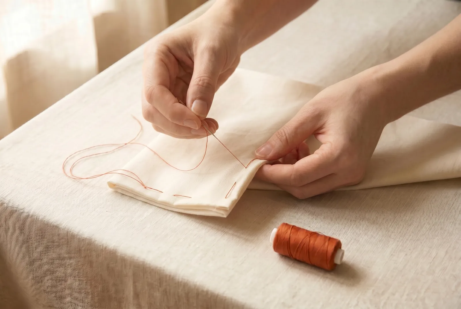 Photo: Secure your thread to the cloth where the seam begins.