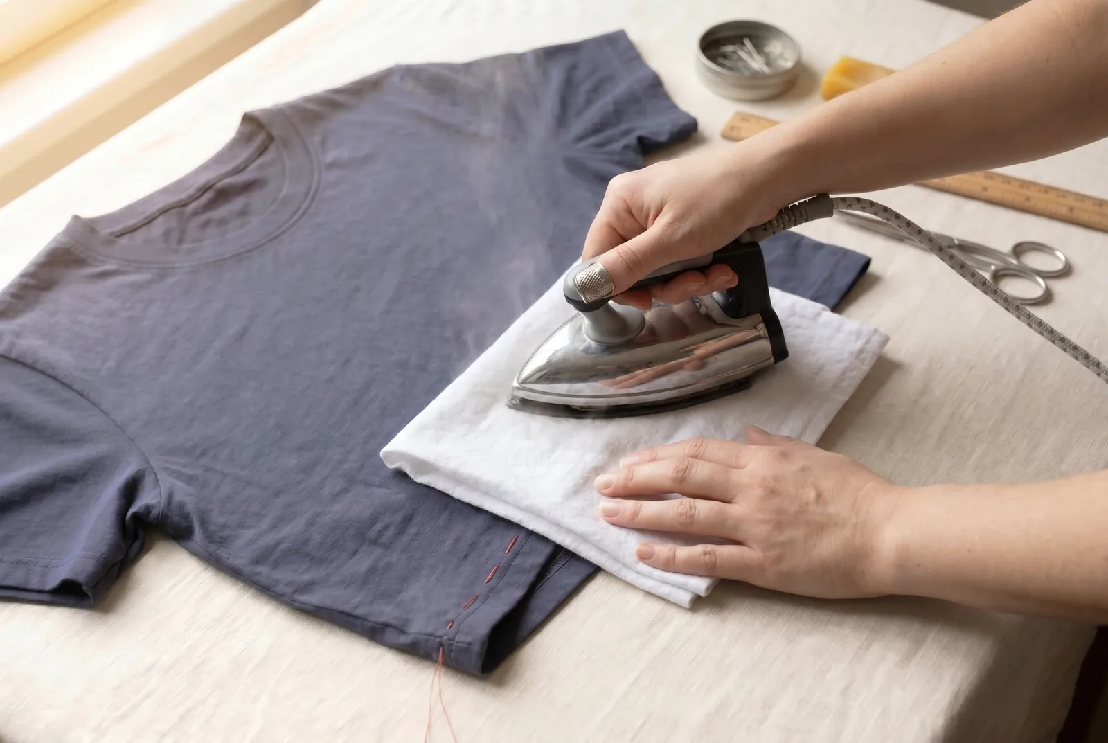 Photo: Press the finished hem on the wrong side under a damp cloth to flatten the fold and the stitches.