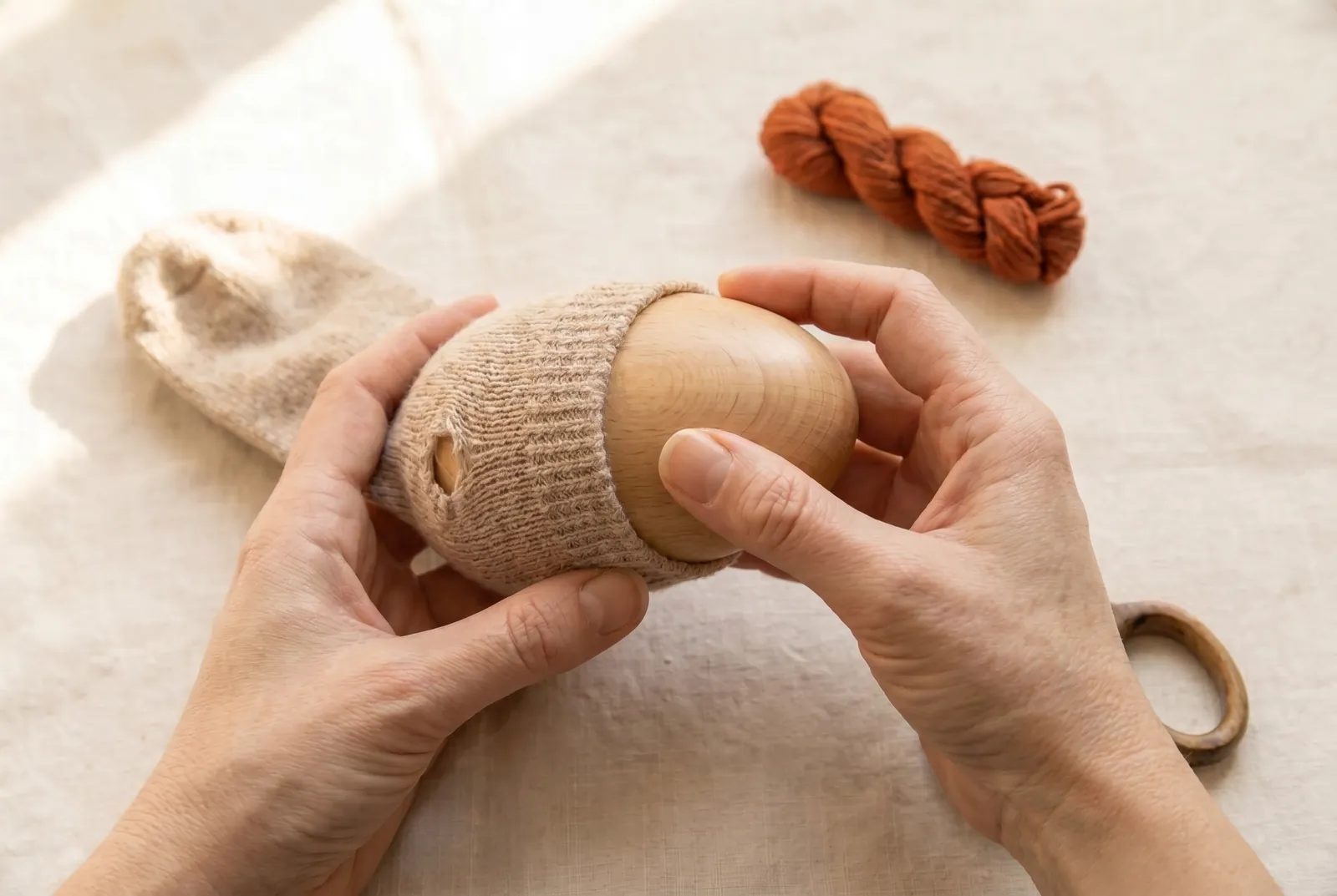 Photo: Slip a darning egg or ball inside the sock, directly under the hole.