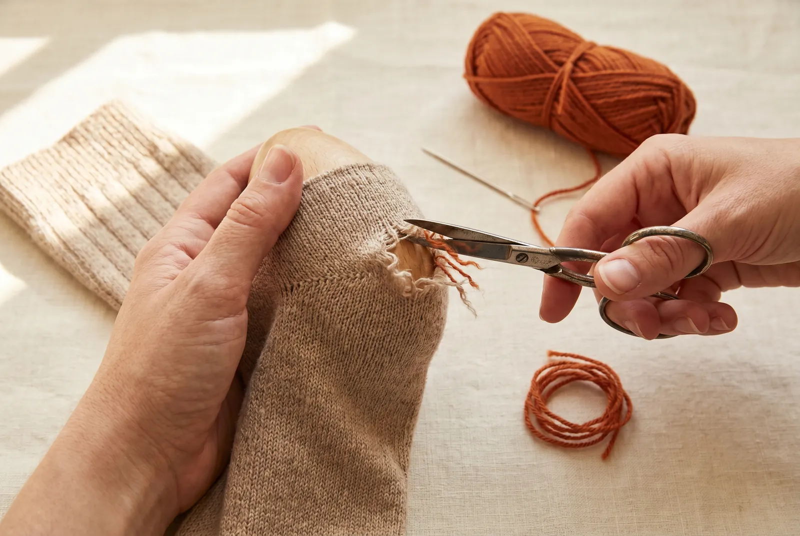 Photo: With small scissors, trim away only the ragged, frayed ends around the hole, and cut no sound loop of the knit.