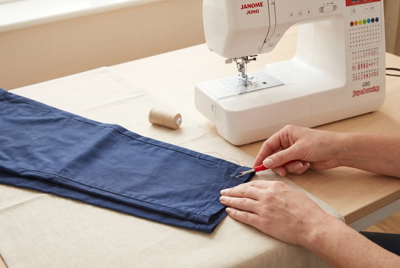 Photo: If you're reusing fabric from the original hem, unpick the old stitching with a seam ripper and press the leg flat before continuing.