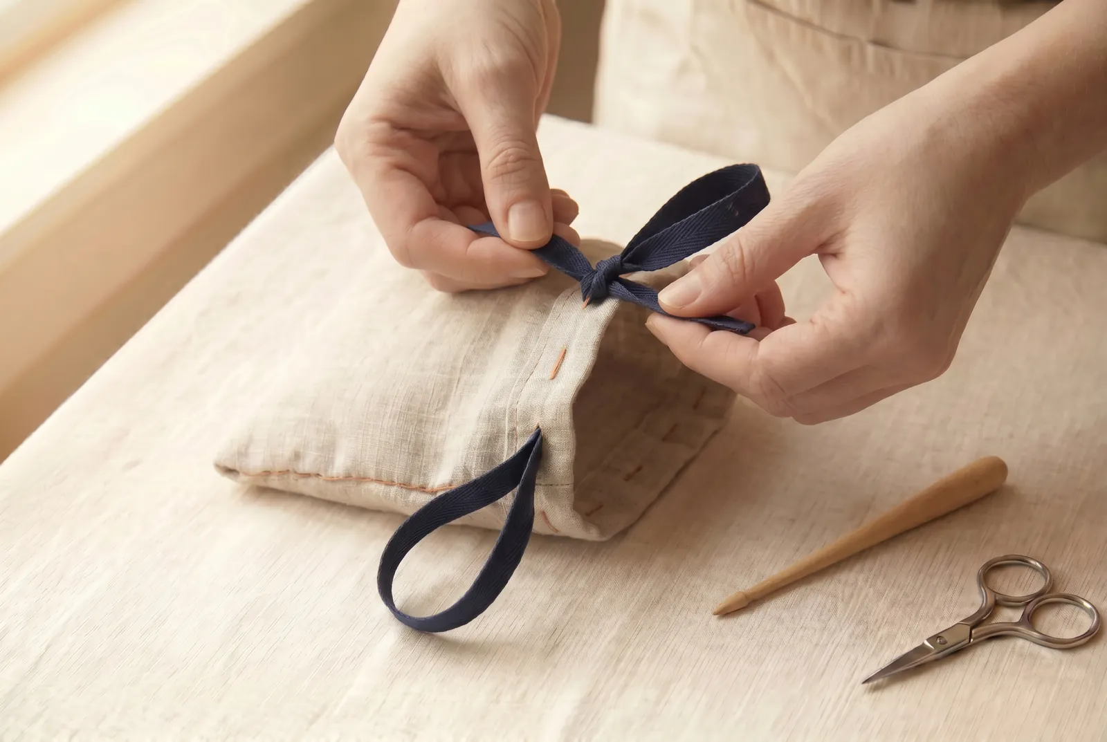 Photo: Run the second drawstring the same way, starting from the opening on the opposite side, and join its two ends.