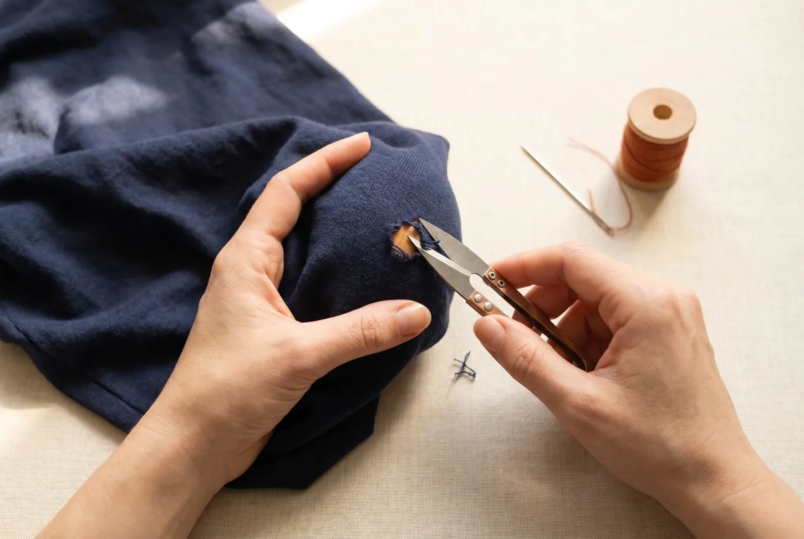 Photo: With small, sharp scissors, trim away only the frayed, ragged ends around the hole.