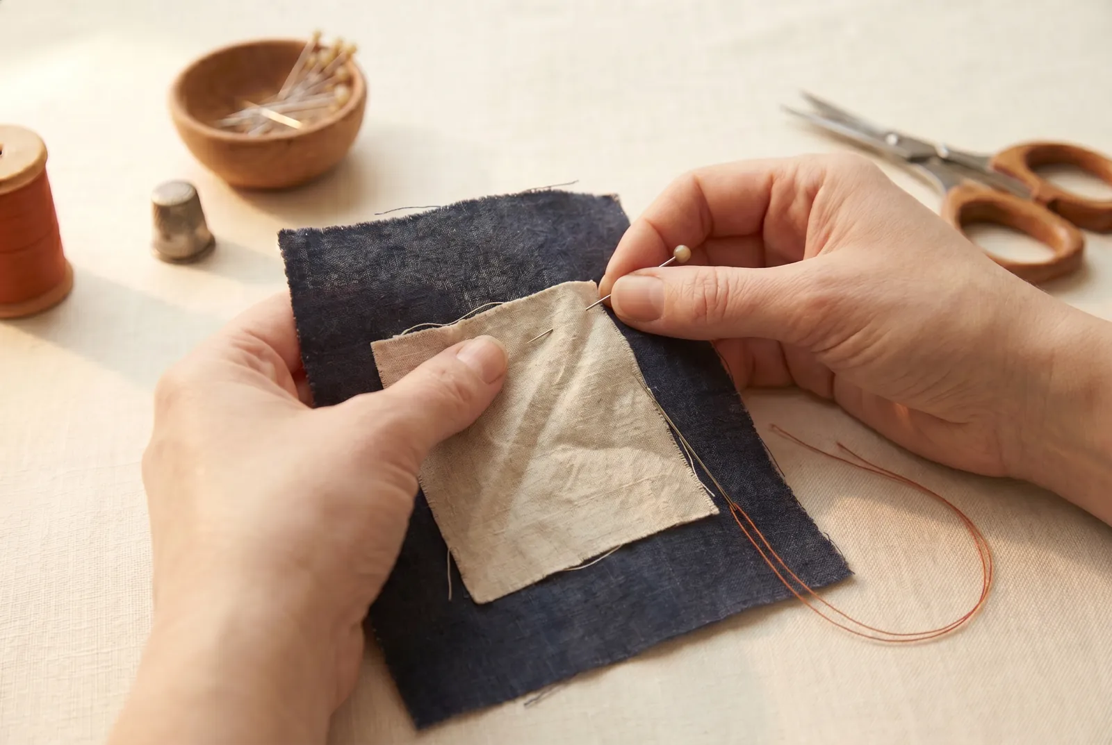 Photo: Pin the two layers together along the line where they will be sewn so they cannot slide apart while you handle the cloth.