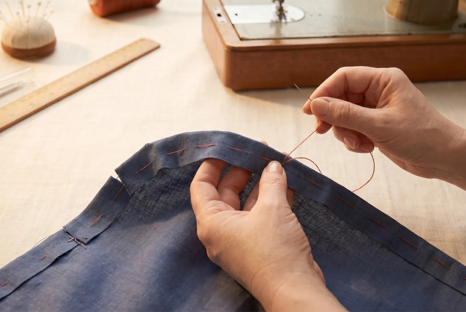 Photo: If your seam curves — for example where a sleeve is felled into a shirt — clip the under edge wherever it pulls and ease the fold to lie smooth around the curv…