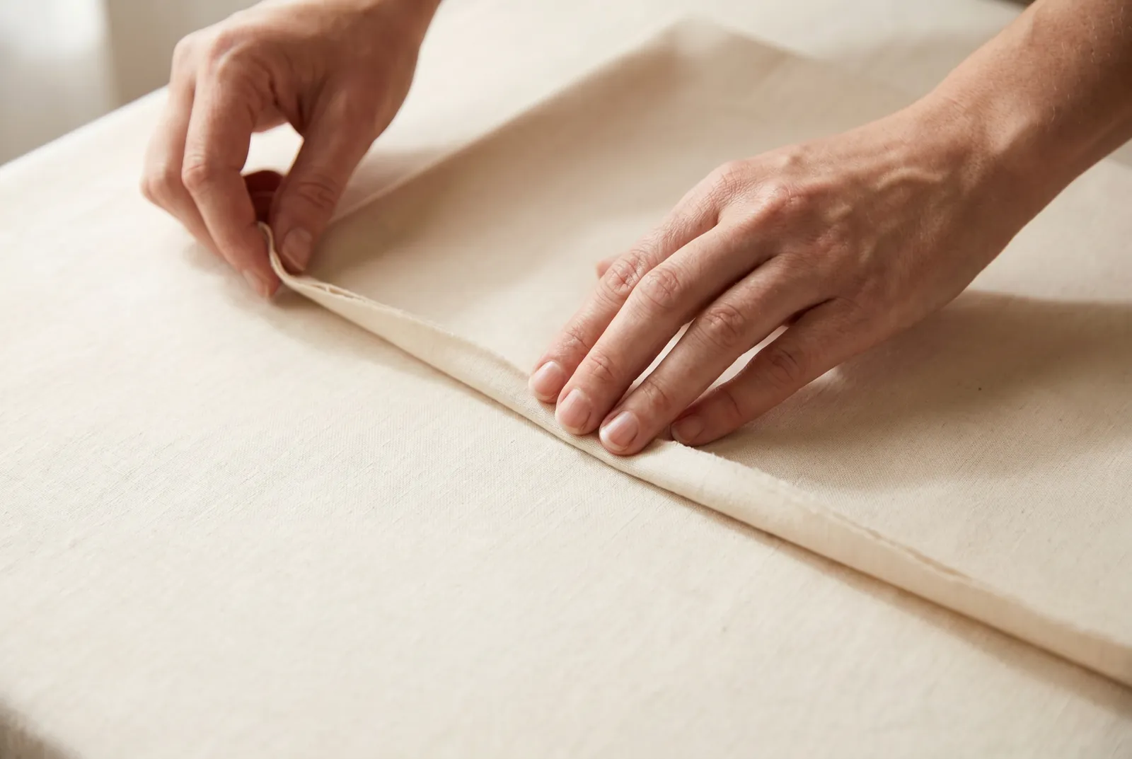 Photo: Pick a straight or nearly straight seam on light fabric — the side seam of a skirt, a pillowcase, or a drawstring bag in cotton or linen.