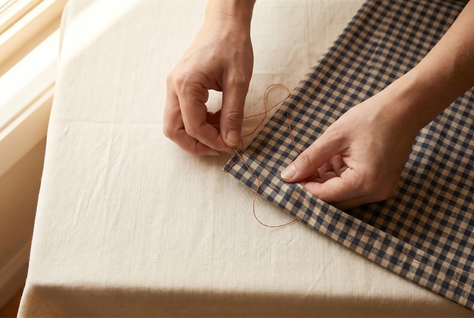 Photo: Along each long side, fold the raw edge a quarter inch (6 mm) to the wrong side, then fold it the same amount again so the raw edge is tucked inside a narrow d…
