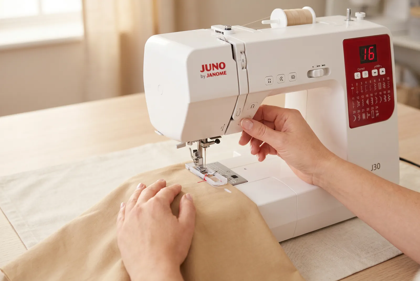 Photo: Slide the fabric under the foot until the chalk mark lines up with the guide mark on the buttonhole foot, then lower the presser foot.