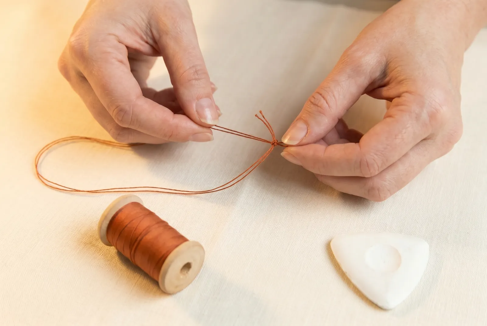 Photo: Cut about 60 cm (24 in) of strong thread, fold it in half, and knot the two cut ends together so you are sewing with a doubled strand.