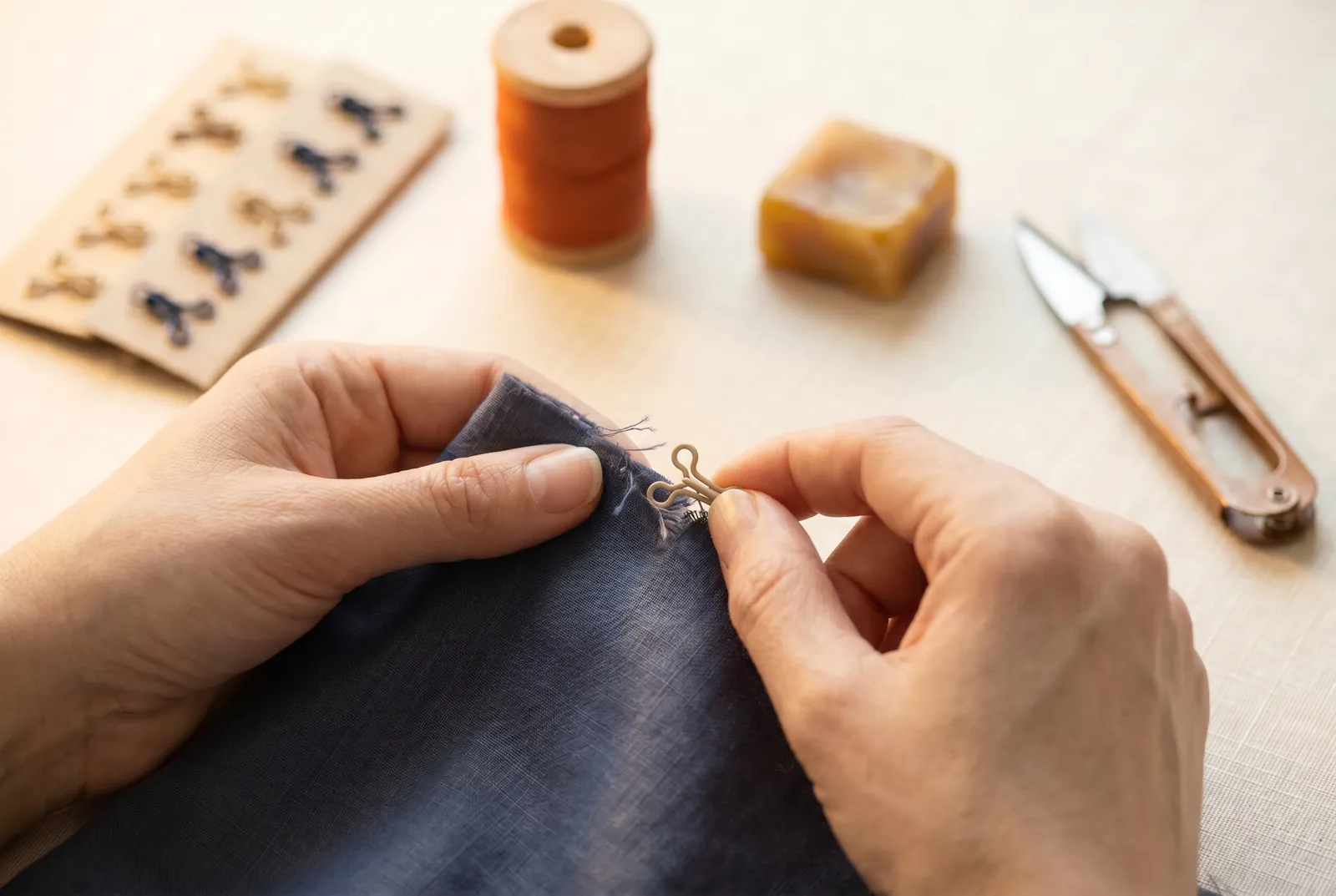 Photo: Run a finger along each hook and eye at the plackets, cuff ends, and any point where strain gathers — these fail first.
