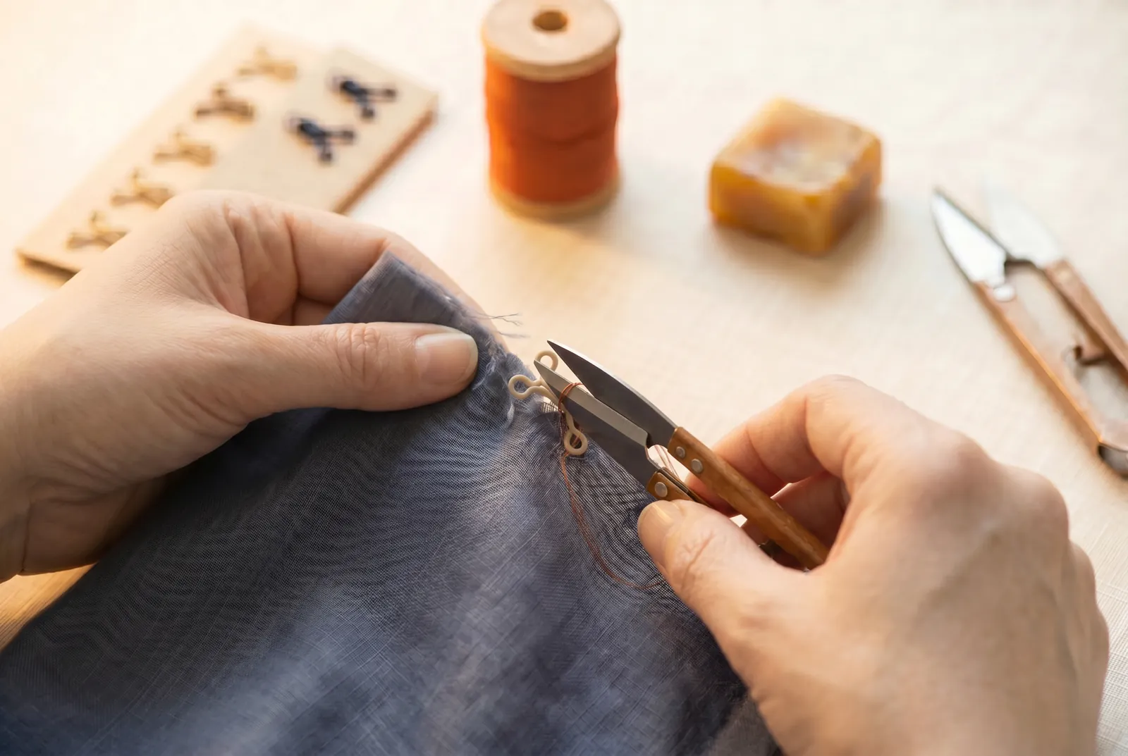 Photo: If you have no new fastener, take a sound hook or eye off a garment you are cutting down or discarding — cut the threads that hold it with small scissors or a…