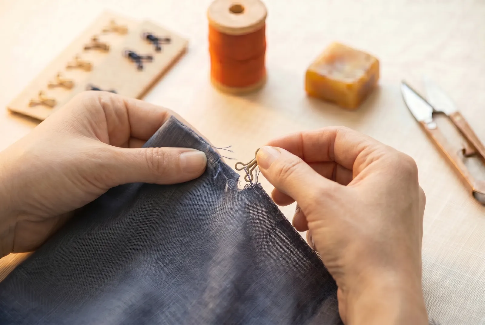 Photo: Check whether the loose fastener has pulled through and torn the cloth of the placket.
