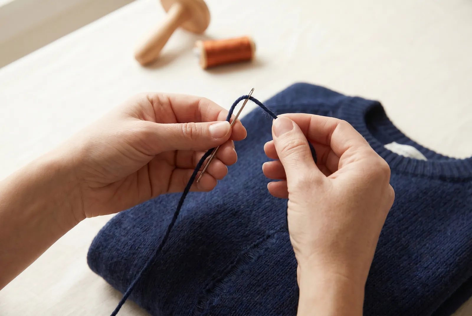 Photo: Choose a soft wool yarn that matches the sweater's color and weight, and thread it on a blunt tapestry needle.
