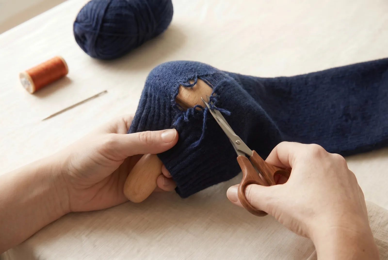 Photo: For an actual hole, set the hole over the darning ball and trim the ragged, frayed ends close with the sharp scissors so you have clean, sound loops to weave f…