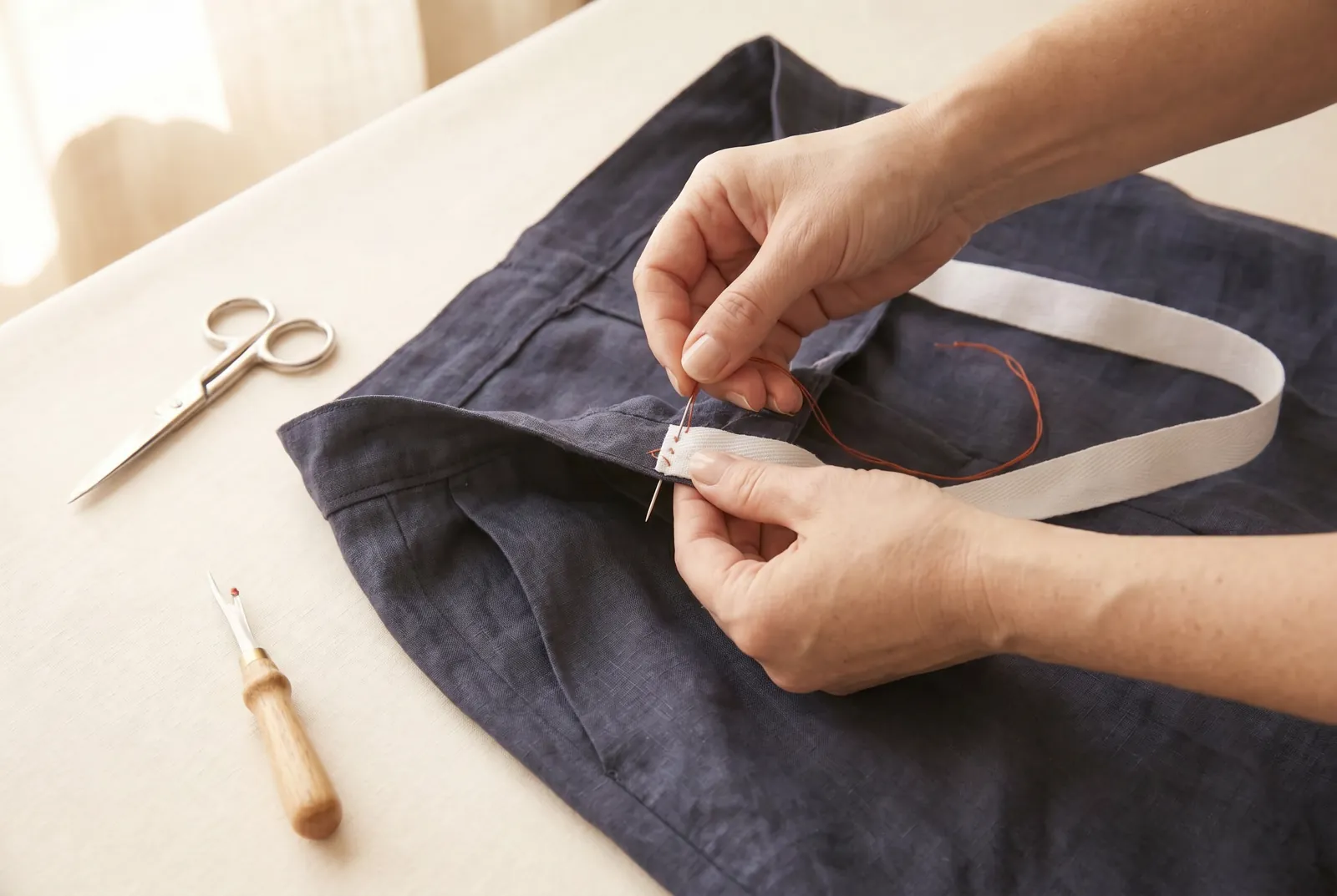 Photo: Cut a length of white cotton tape 2 cm (3/4 in) wide, a few centimetres longer than the back span between the side seams.