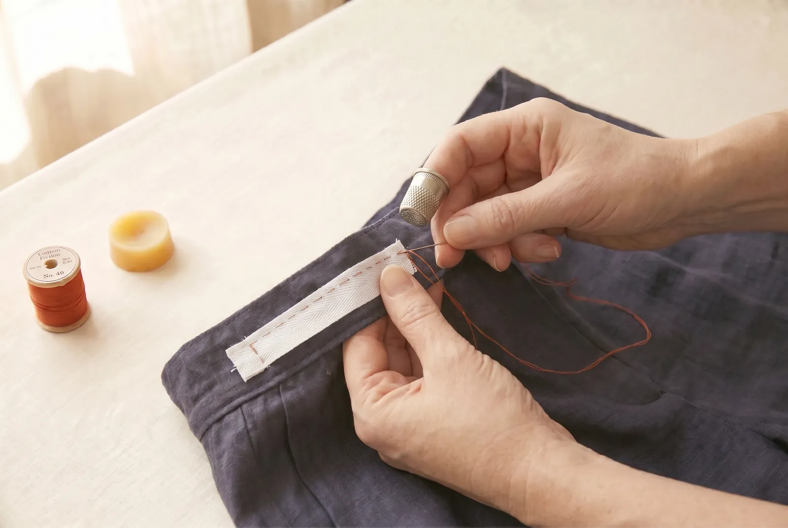 Photo: Stitch the free end of the tape firmly to the waistband at the second side-seam opening, matching the way you fastened the first end.