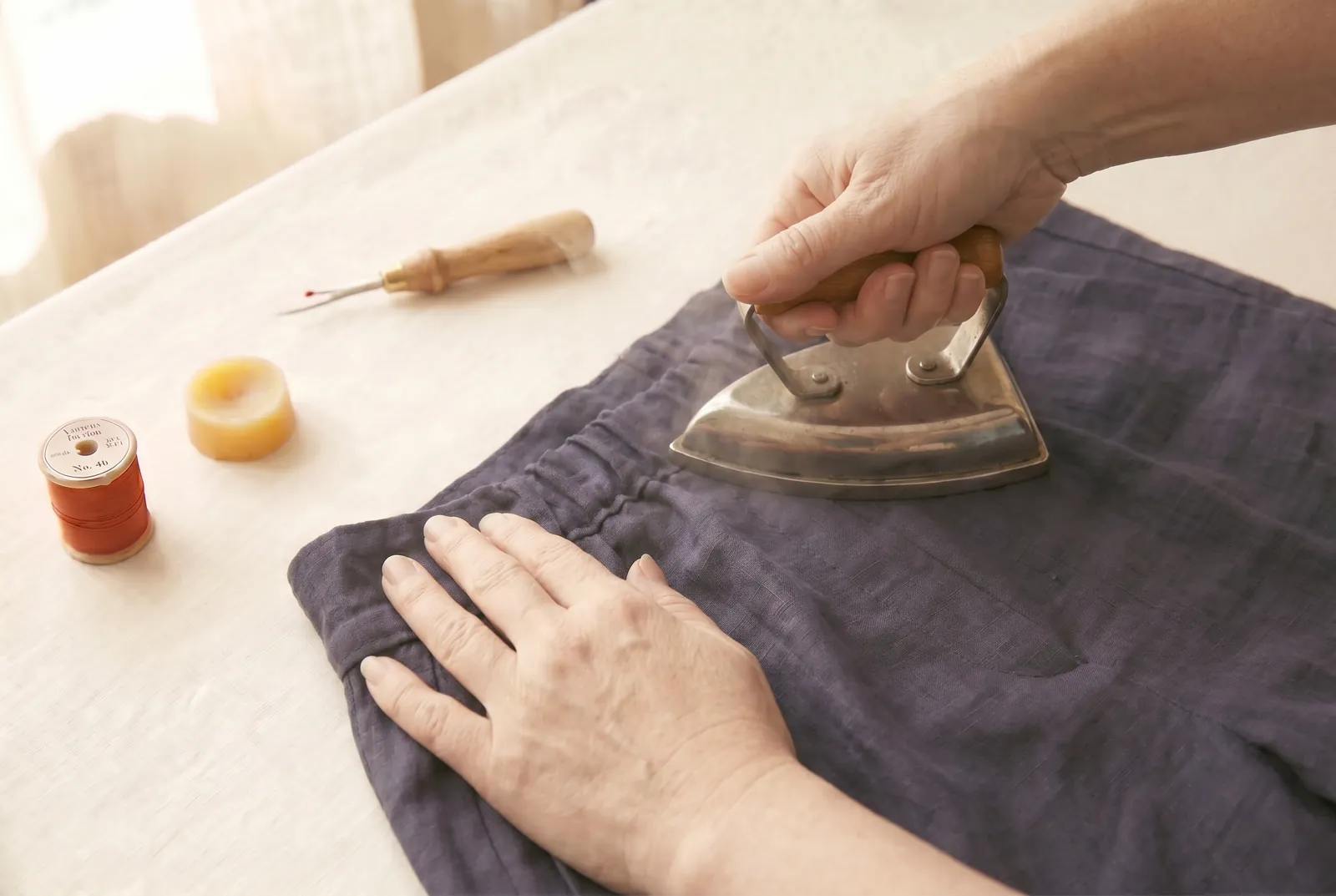 Photo: Press the gathered back flat with a warm iron to set the gathers and settle the tape inside the channel.