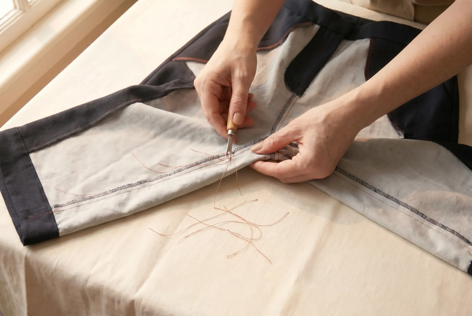 Photo: Take out the basting: cut its thread every few inches and draw out the short lengths.