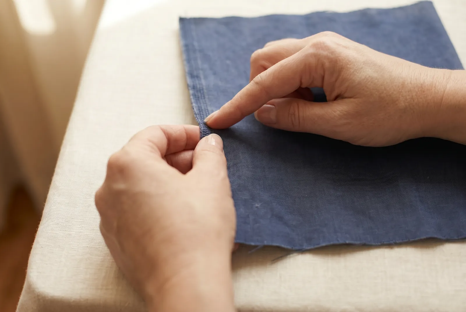 Photo: Look at the threads that run the length of the piece, parallel to the selvage: these are the warp, the set put on the loom first and drawn tight.