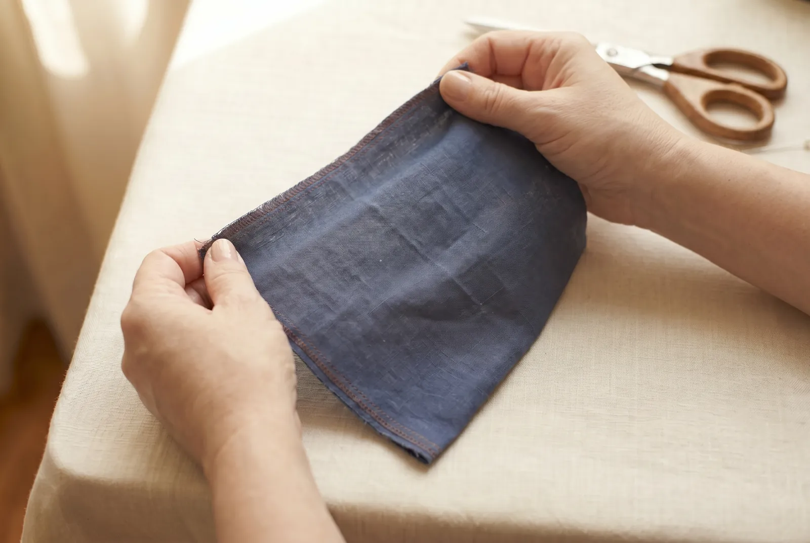 Photo: Now pull on the diagonal, slanting across both sets of threads: this slant is the bias, and the true bias at forty-five degrees stretches more than either stra…