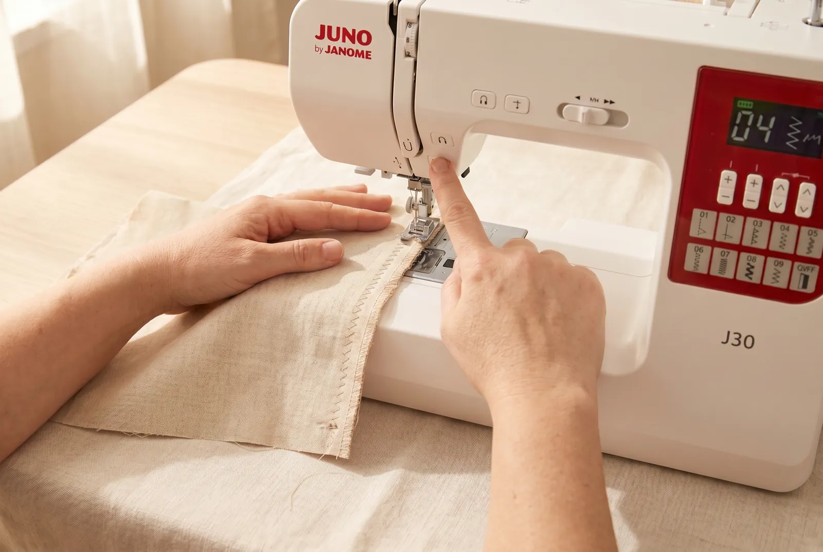Photo: Lower the presser foot, sew a few stitches, then use the reverse button to backtack and lock the start of the stitching.